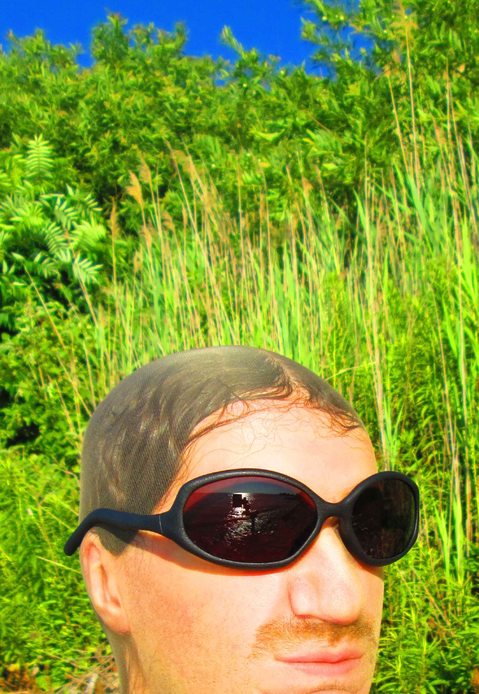 3D render of a bald model wearing black sunglasses with transparent grey lenses